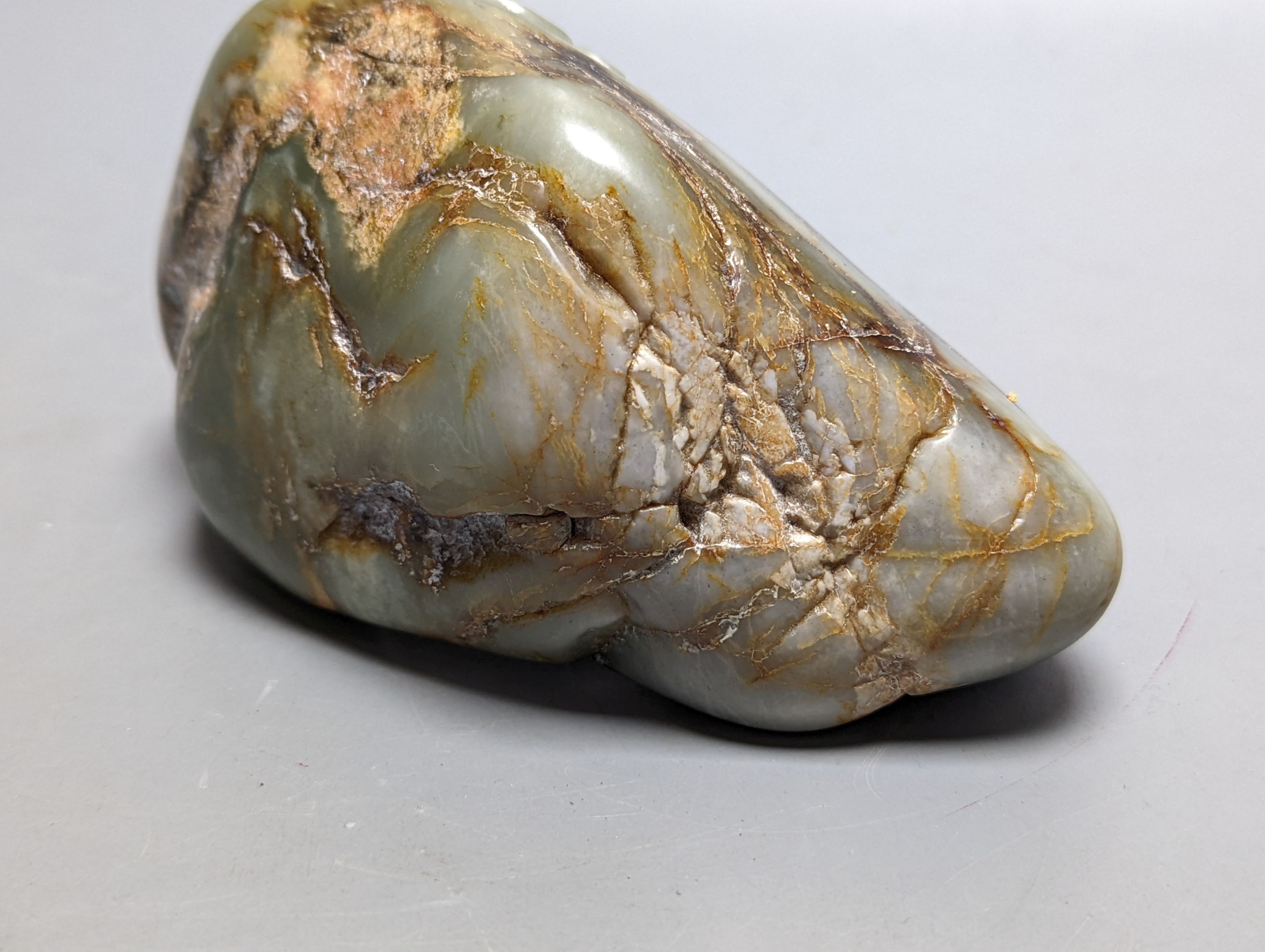 A Chinese celadon and russet jade boulder carving 16cm